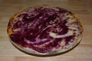 Gluten free blackberry swirled cheesecake atop a chocolate cookie crust.