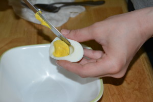 Gently remove egg yolks, adding them to a small bowl. 