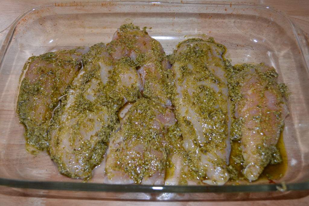 Layer the chicken breasts with pesto sauce.