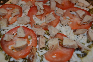 Diced chicken added evenly over pizza.