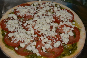 Gluten Free pesto goat cheese pizza ready for the oven!