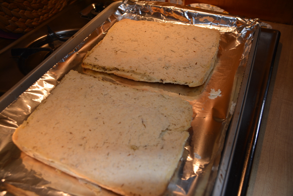 Focaccia loaf cut in half lengthwise.