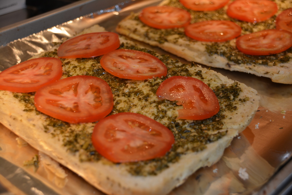 Add tomato slices on top of pesto layer. 