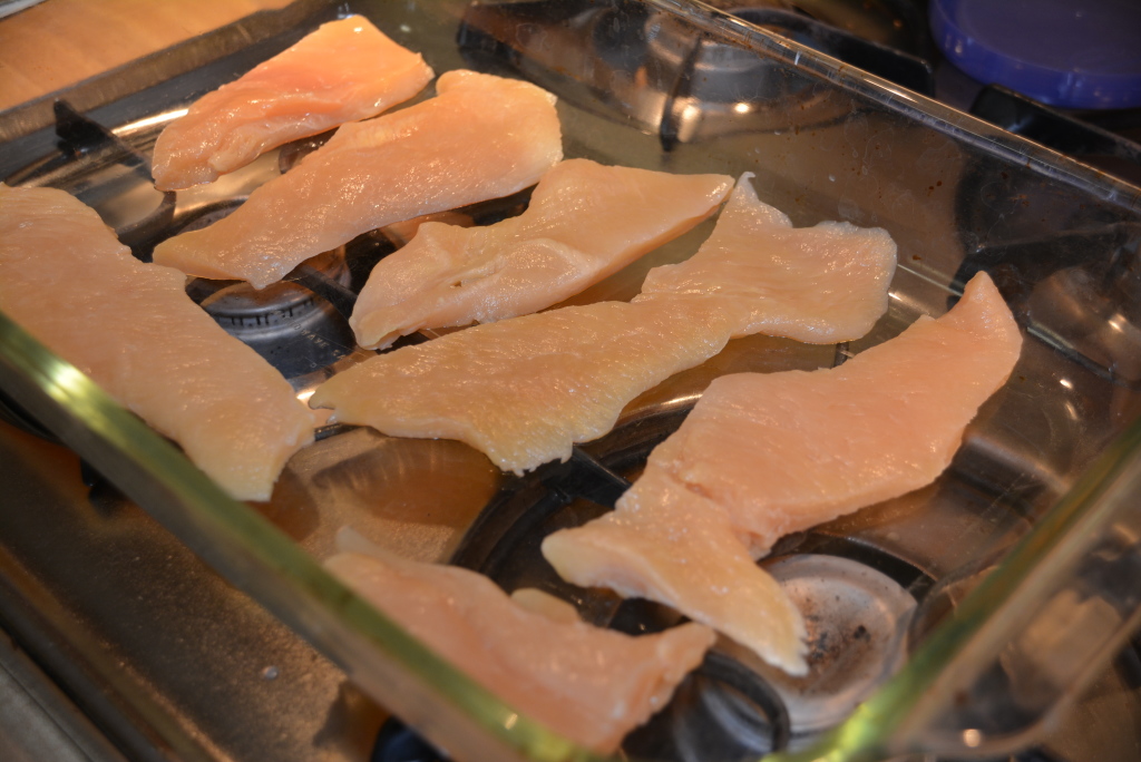 Clean and trim chicken breasts before adding them to your baking dish.