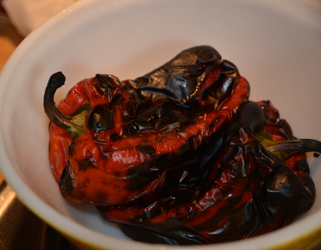 Roast your red peppers on the grill until the skins turn black. 