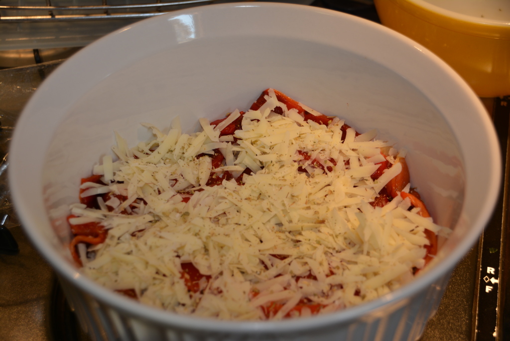 Sprinkle red peppers with shredded sharp provolone cheese.