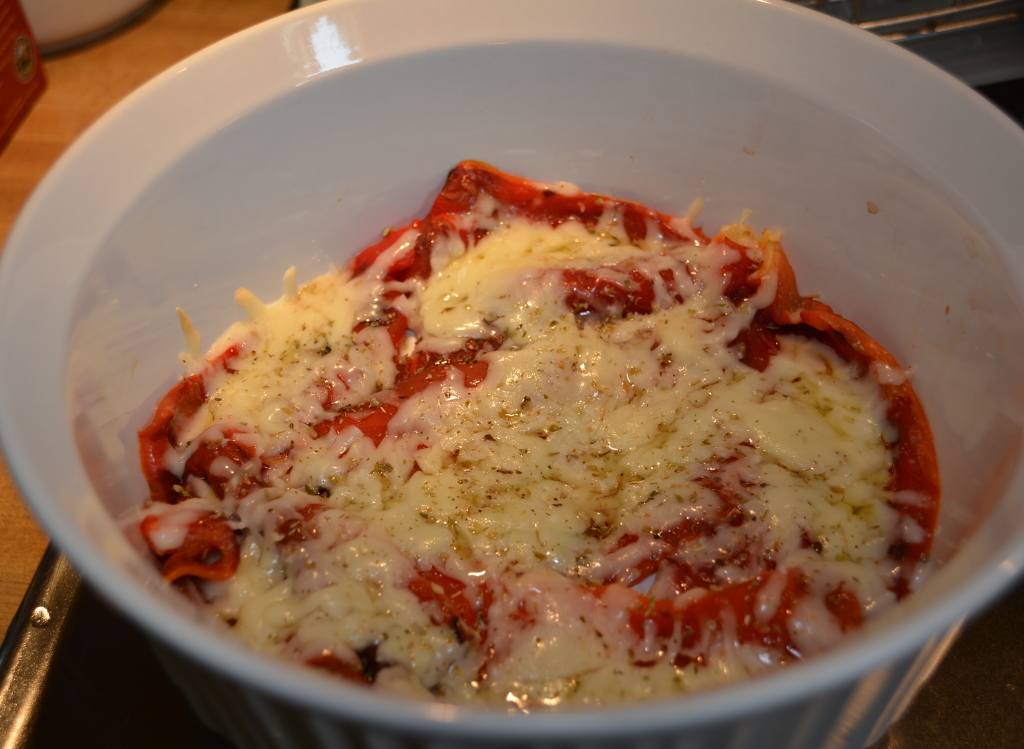 Melt shredded sharp provolone cheese on top of red peppers.