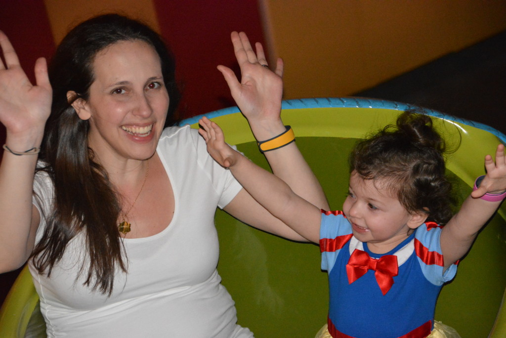 Nighttime Mommy and little girl Dumbo ride.