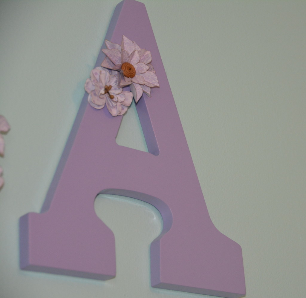 Lilac letters with floral accents.