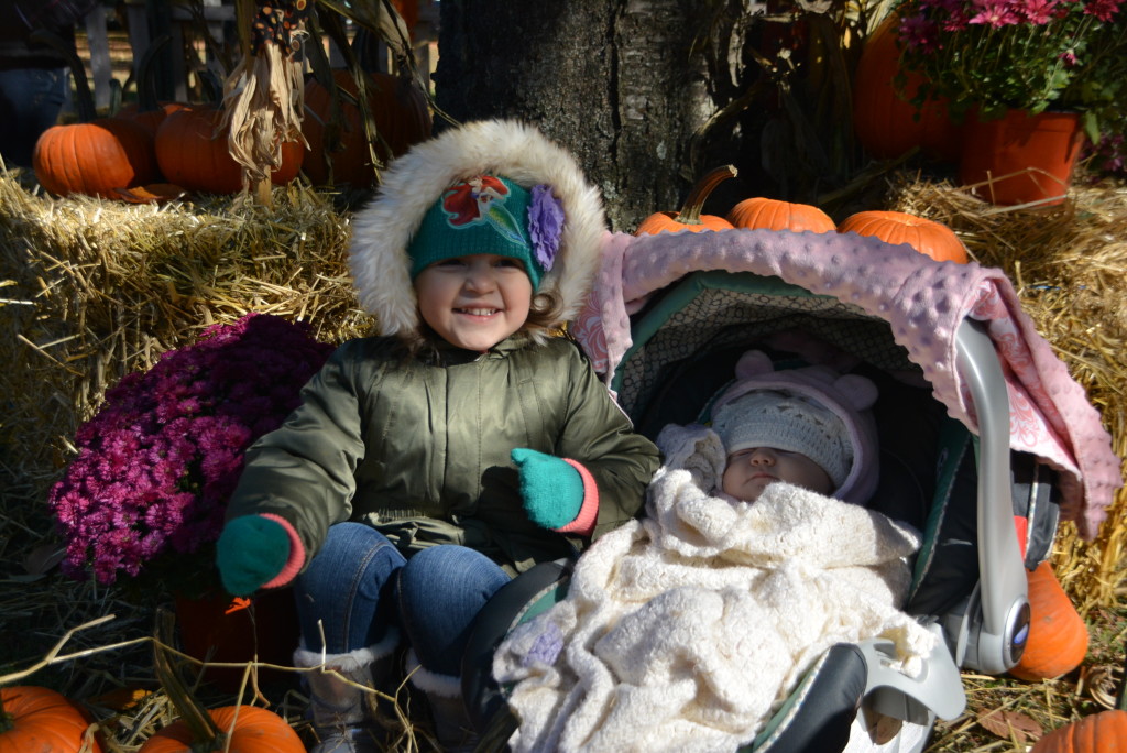 Showing her little sister how to pick just the right pumpkin!